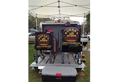 Logo decal on a smoker by Custom Graphics and Signs